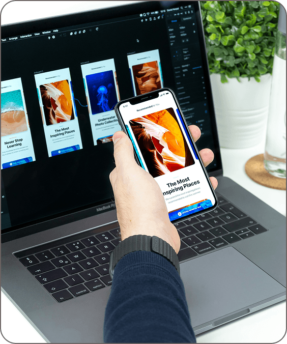 Interactive prototype on a smartphone beside a laptop