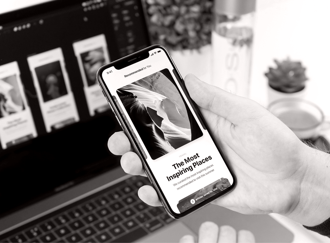 Interactive mobile app prototype on a smartphone beside a laptop