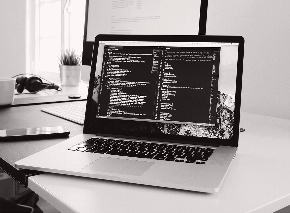Developer workspace with HTML and CSS open on a laptop screen