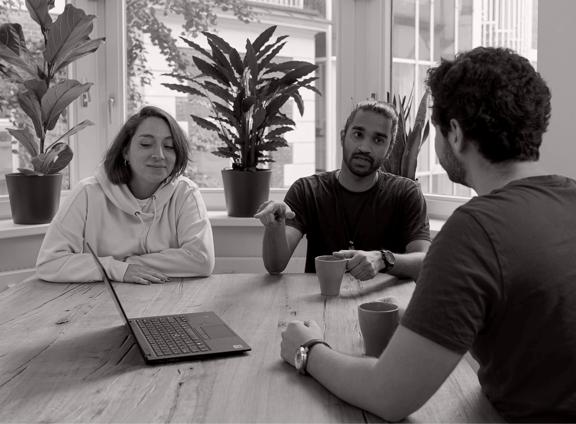 Team collaborating around a table during a stakeholder review session