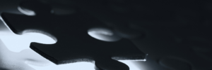 Close up of backlight puzzle piece in a dark setting.