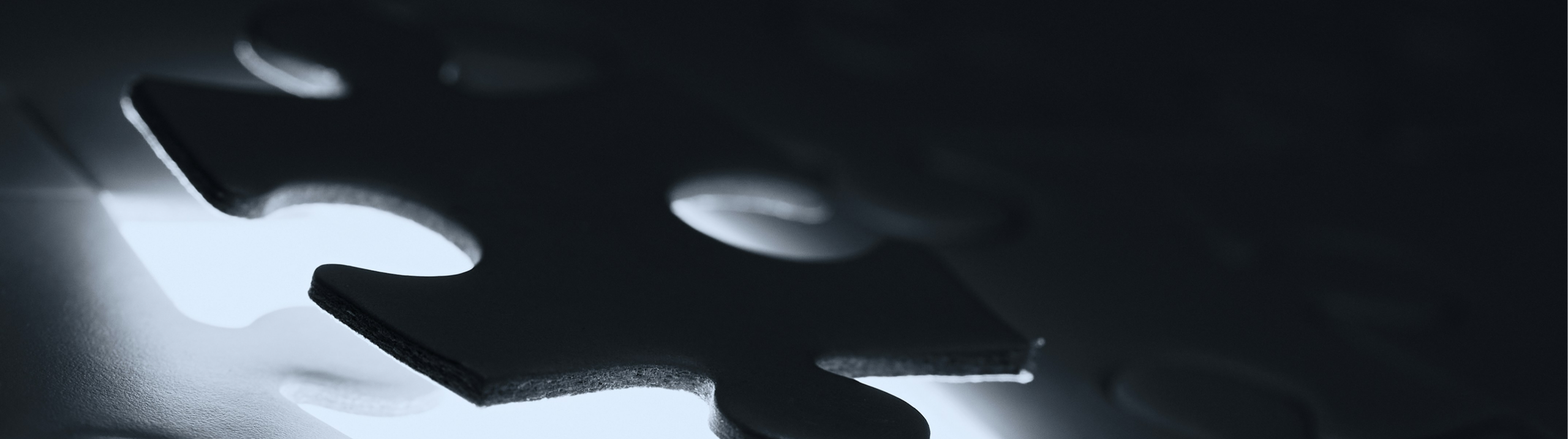 Close up of backlight puzzle piece in a dark setting.
